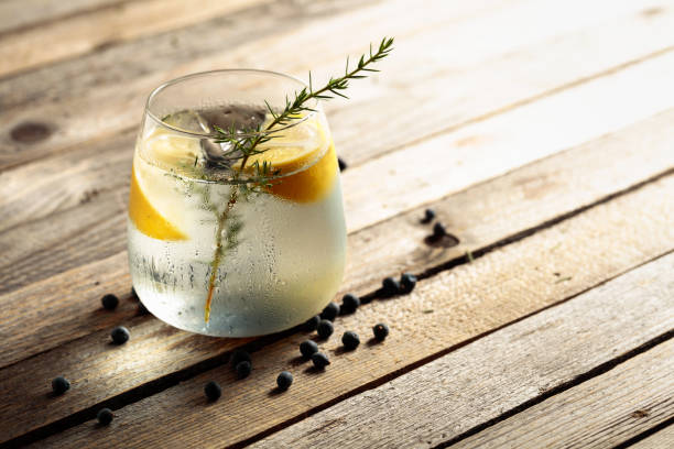istock Iced cocktail drink with lemon and juniper berries. 1331447176