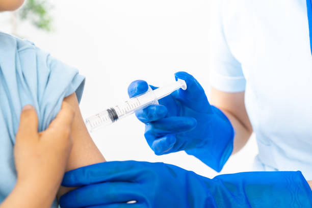 istock Boy getting a shot at a hospital 1331450614