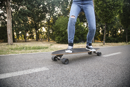 top photo of an skate and feet of a young skater on top of it