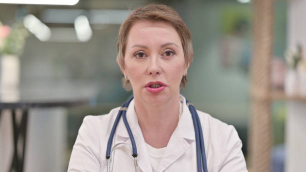 istock Friendly Middle Aged Female Doctor Talking on Video Call 1331454366