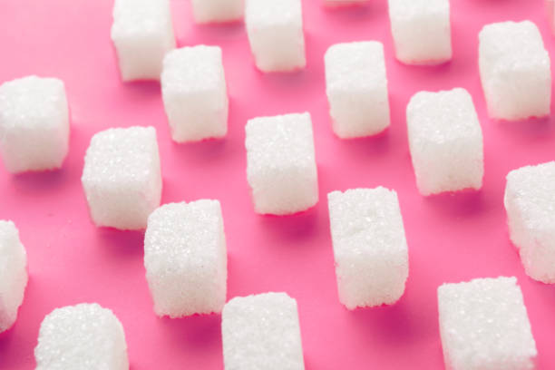 istock Cubes of sugar on bright pink background 1331455364