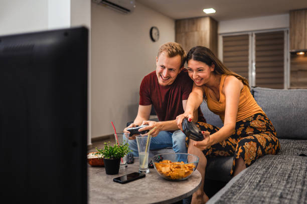 istock Young couple playing video game together 1331460239