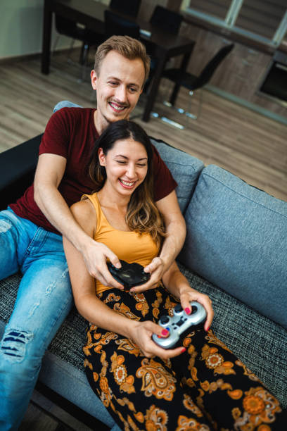 istock Young couple playing video game together 1331460328