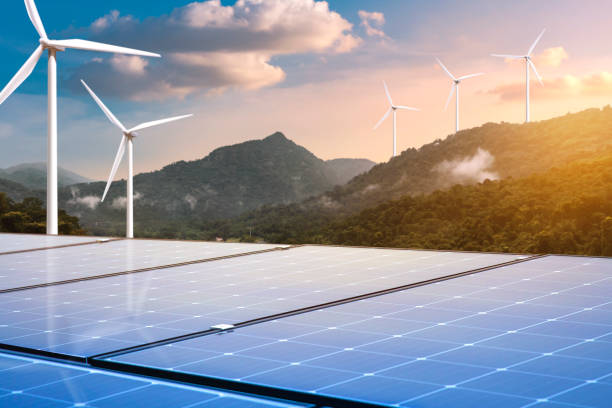 istock solar panels with wind turbines on mountains landscape 1331461853