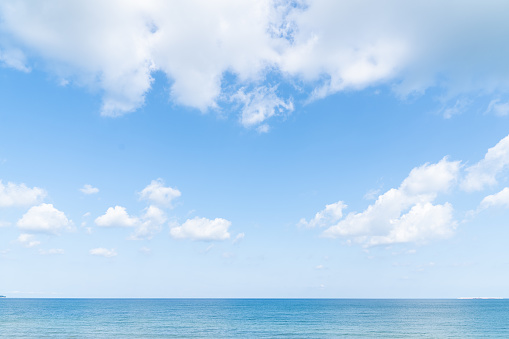 Idyllic photo of a calm sea and sky divided by the horizon.