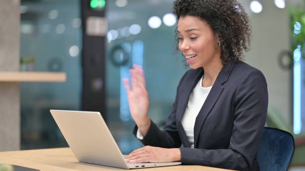istock Talking African Businesswoman Doing Video Chat at Work 1331468514