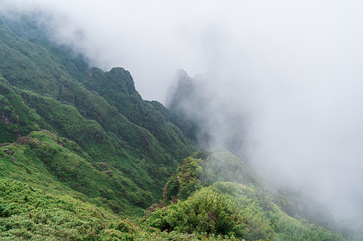 Clouds cover half of the mountain cliff of Fansipan mountain, Lao Cai province, North Vietnam