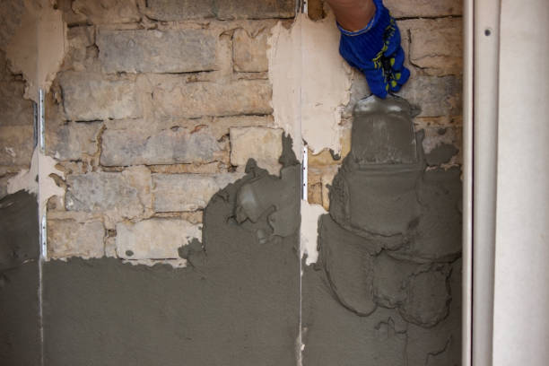 istock man plastering the wall. Construction, repairs in the house. 1331472725