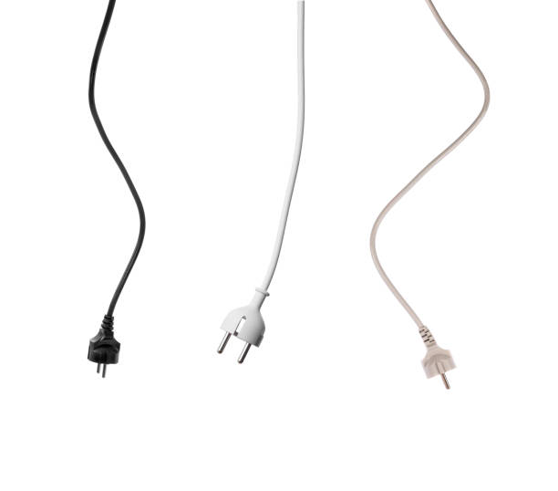 Set of different European plugs on the cable hang down on white