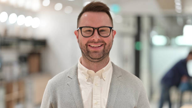istock Smiling Casual Young Man Looking at Camera 1331472946