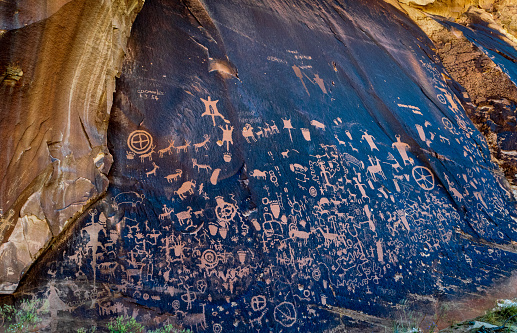 A large display of Native American petroglyphs create a dazzling display of primitive art at Newspaper Rock National Monument.