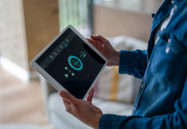 istock Woman controlling the music in her house using a home automation system 1331473757