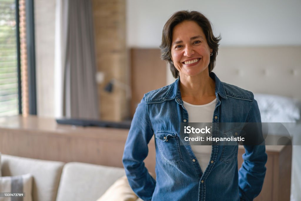 Happy Latin American woman smiling at home Portrait of a very happy Latin American woman at home and looking at the camera smiling Women Stock Photo