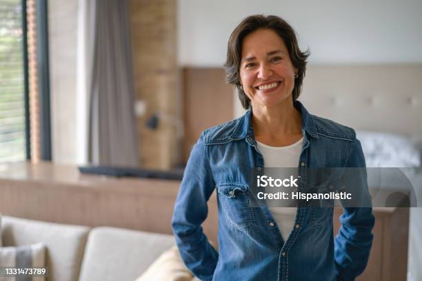 Happy Latin American Woman Smiling At Home Stock Photo - Download Image Now - Women, One Woman Only, Domestic Life