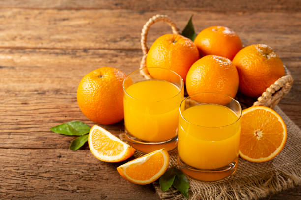 istock Glass with orange juice on the table. 1331476907