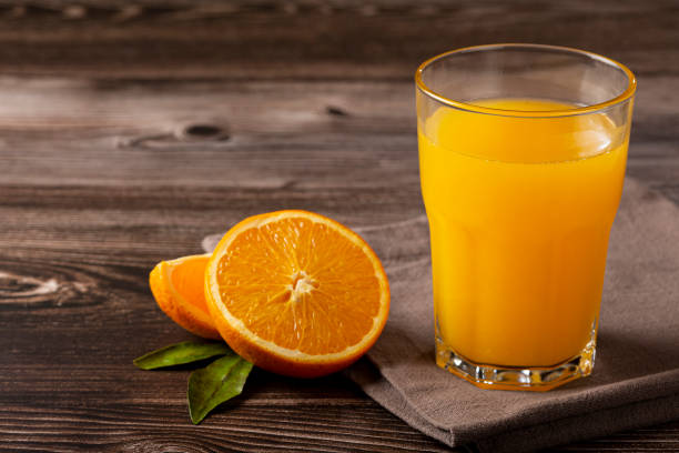 istock Glass with orange juice on the table. 1331476994