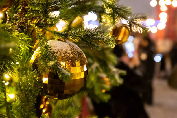 ball festive christmas tree decoration golden brown closeup on spruce branches with copy space ball festive christmas tree decoration golden brown closeup on spruce branches with copy space 11313 stock pictures, royalty-free photos & images