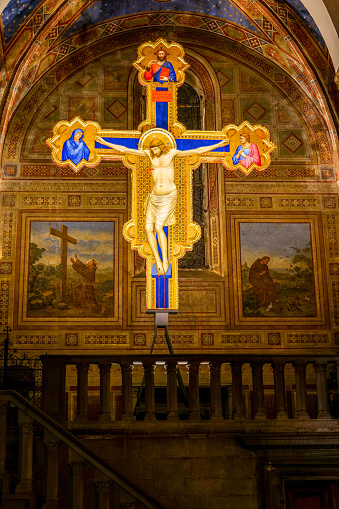Florence, Tuscany, Italy, August 11 -- The chapel with the beautiful Crucifix painted in 1315 by Giotto (Giotto's Crucifix), inside the transept of the Franciscan church of San Salvatore di Ognissanti, or simply Chiesa di Ognissanti (Church of All Saints), in the historic heart of Florence. Inside the church, built starting from 1251 and completed in 1637 in Baroque style, there are also some artistic masterpieces by Domenico Ghirlandaio and Sandro Botticelli. In this church there is the tomb of Sandro Botticelli. Since 1982 the historic center of Florence has been declared a World Heritage Site by Unesco. Image in high definition format.
