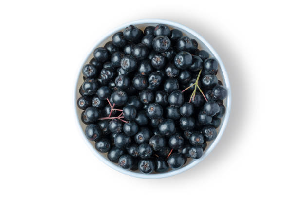 istock Black rowan. Ripe berries in a white plate. Isolated on white 1331480579