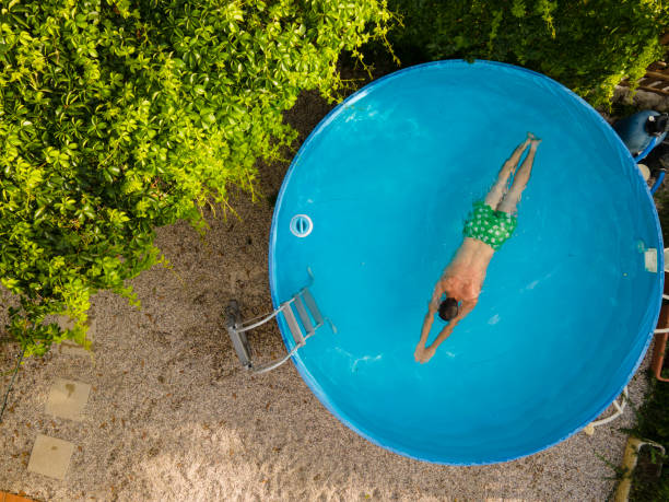 istock Directly Above Young Man Swimming in Backyard Swimming Pool 1331480618