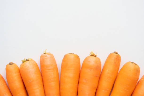istock Ripe carrots on a light beige background 1331480830