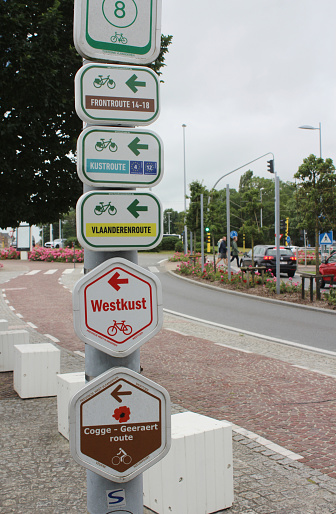 Nieuwpoort, Belgium, 15 July 2021: Signpost with directional information for a number of different cycle routes in West Flanders. Cycling is a hugely popular sport in Flanders.