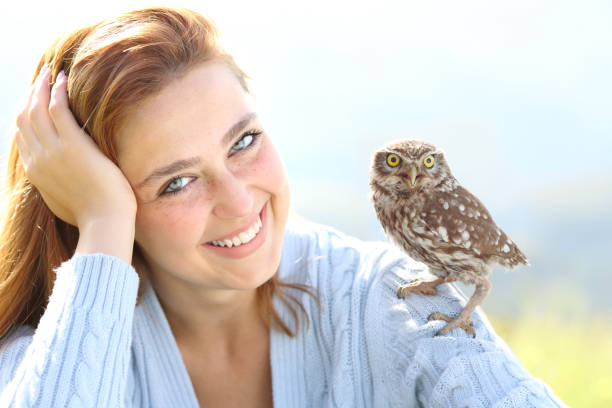 istock Beautiful woman with blue eyes posing with an owlet 1331483352