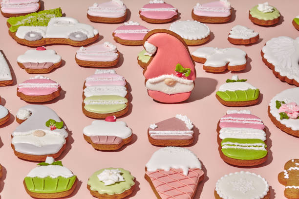 istock Sugar coated gingerbread gnome among ginger cookies on pink background 1331484431