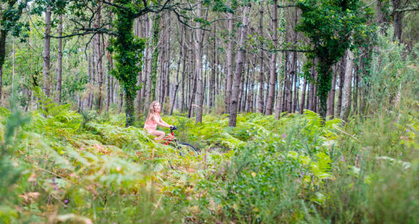 istock young girl riding a bicycle on a cycle path through a beautiful forest 1331484973