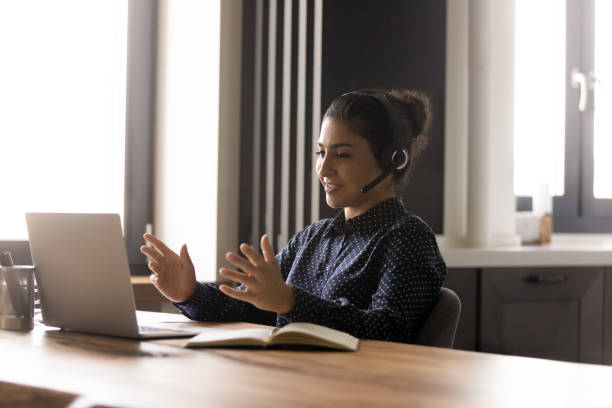 istock Happy Indian telemarketing manager, support center operator working with client 1331487205