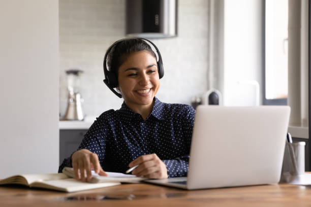 istock Happy Indian student in headphones with microphone attending virtual training 1331487208