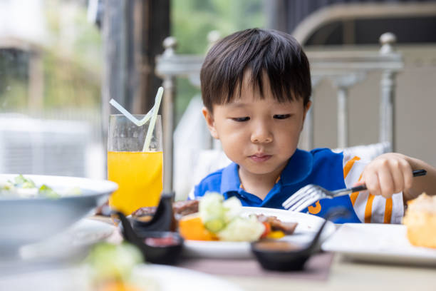 istock A little boy eating steak in a restaurant 1331488227