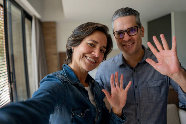 istock Happy couple at home greeting on a video call 1331490695