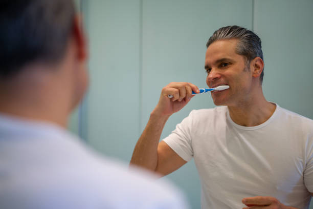 istock Man at home brushing his teeth in the bathroom 1331490765