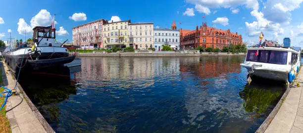 Panorama of the city embankment and river transport on a sunny day. Bydgoszcz. Poland.