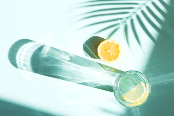 istock Cool summer drinks - lemonade or soda in glass on blue color background with palm tree leaf shadows 1331491973