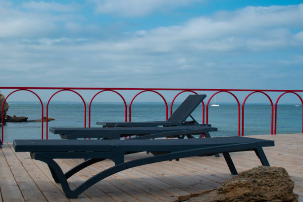 istock Sun loungers or reclining chairs on the sea shore 1331492607