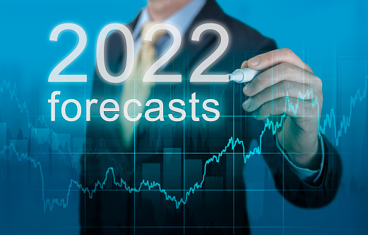 previsiones económicas para 2022. el empresario escribe las previsiones para 2022 en pantalla virtual. Previsiones de Año Nuevo 2022. Empresario en traje pronóstico plan de análisis gráfico de beneficios con pluma photo