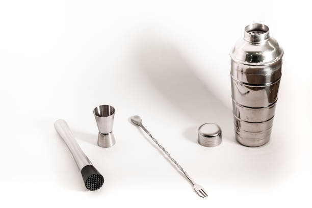 istock Professional bartender kit set. Cocktail shaker, bar spoon, Jigger and Muddler isolated on white background. Cocktail banner with copy space for text 1331499462