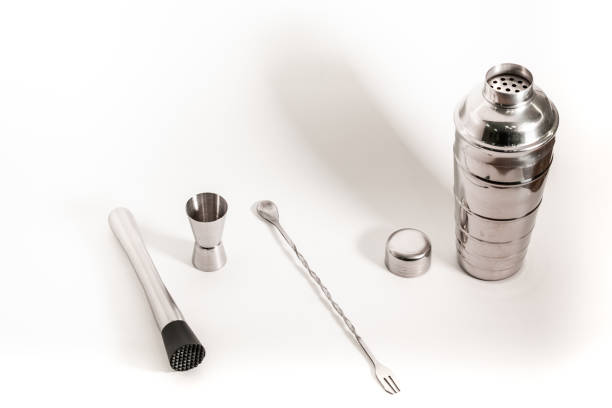 istock Professional bartender kit set. Cocktail shaker, bar spoon, Jigger and Muddler isolated on white background. Cocktail banner with copy space for text 1331499464