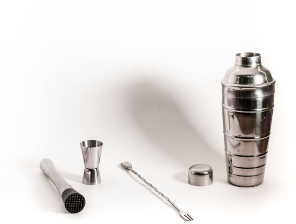 istock Professional bartender kit set. Cocktail shaker, bar spoon, Jigger and Muddler isolated on white background. Cocktail banner with copy space for text 1331499468