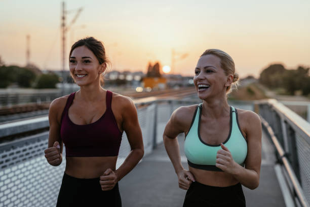 istock Two women exercising together outdoors in summer evening 1331499491