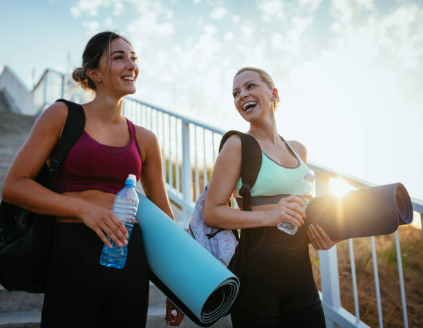 Women exercising together outdoors in summer evening