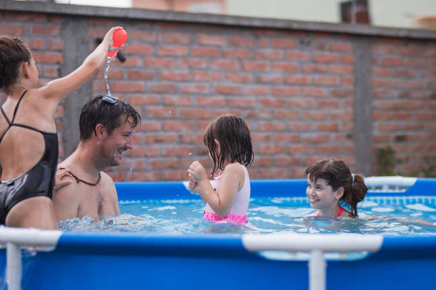 istock Happy man smiling when being sprinkled at the swimming pool 1331501762