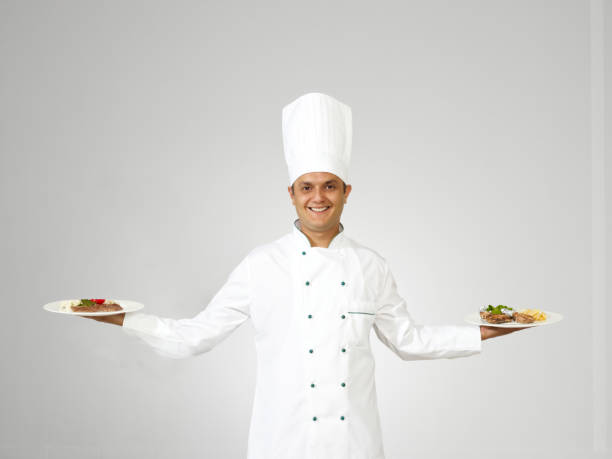 istock Chef holding meat dish and pasta 1331503428