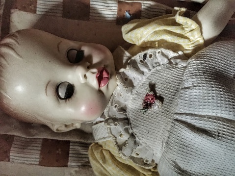 A creepy doll laying down