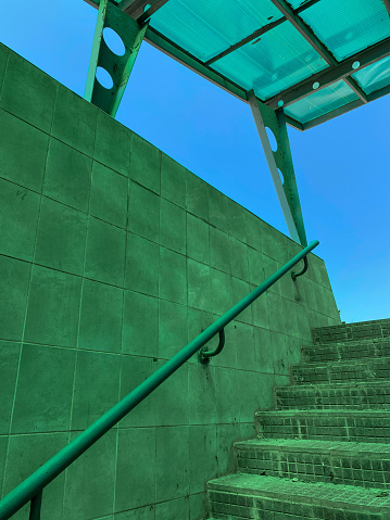 Square green lit tiles. Underpass. Matrix. Perspective. Lines. Shapes.