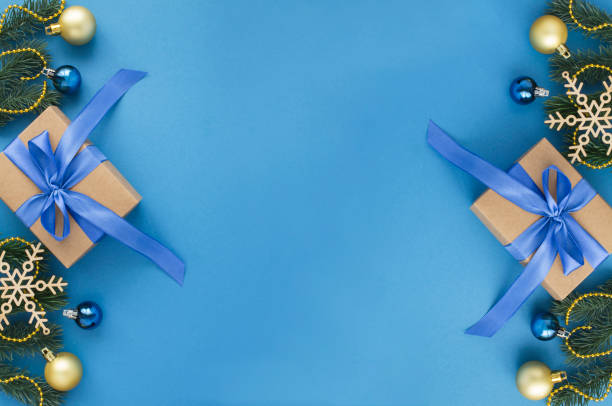 istock Christmas gift with tied blue bow on the blue background. Top view. Copy space. 1331504329