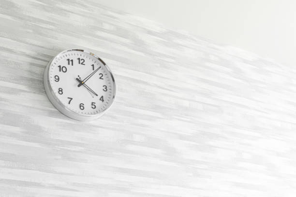 istock Time management concept background with clock on the gray wall, copy space, bright photo 1331509659