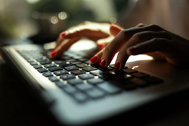 istock Hands Typing on a laptop in morning sun 1331510771